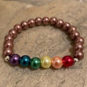 6 1/2-6 3/4”wrist Rainbow glass bracelet. Double knot/glued in. Hand-crafted.